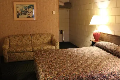 a hotel room with a bed and a couch at Best Continental Motel in Hope