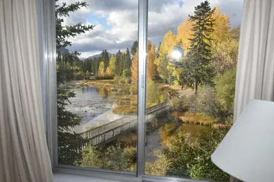 a window with a view of a river at The Drake Inn in Canmore