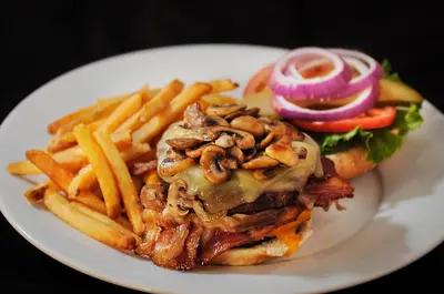 a plate of food with a sandwich and french fries at Chateau Nova Yellowhead in Edmonton