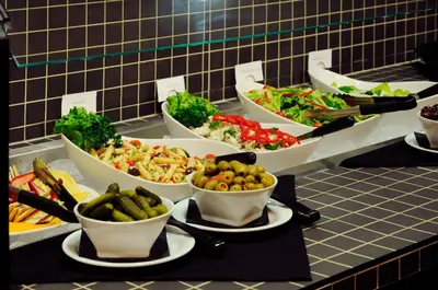 a buffet with several bowls of food on a table at Chateau Nova Yellowhead in Edmonton