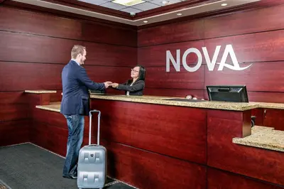 a man and a woman standing at a nova counter at Chateau Nova Yellowhead in Edmonton