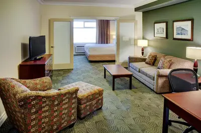a hotel room with a couch and a bed at Chateau Nova Yellowhead in Edmonton