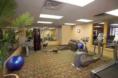 a gym with treadmills and exercise equipment in a room at Chateau Nova Kingsway in Edmonton