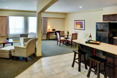 a hotel room with a waiting area and a living room at Chateau Nova Kingsway in Edmonton