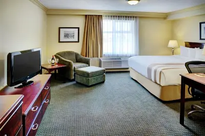 a hotel room with a bed and a television at Chateau Nova Kingsway in Edmonton
