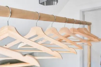 a bunch of wooden hangers hanging from a rack at Minimal - 90 nights min in Vancouver