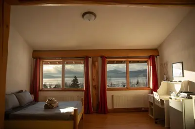a bedroom with a teddy bear sitting on a bed at Williston Lake Resort in Hudson Hope