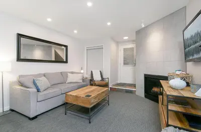 a living room with a couch and a fireplace at Glaciers Reach by Allseason Vacation Rentals in Whistler