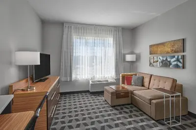 a living room with a couch and a television at TownePlace Suites by Marriott Edmonton Sherwood Park in Sherwood Park