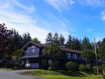 a building with a sign that reads the inn at Tofino Motel Harbourview in Tofino