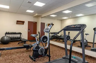 a gym with treadmills and exercise equipment at Super 8 by Wyndham Cochrane in Cochrane