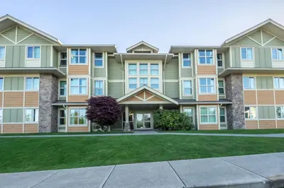 an apartment building with a lawn in front of it at Vancouver Island Residences in Nanaimo