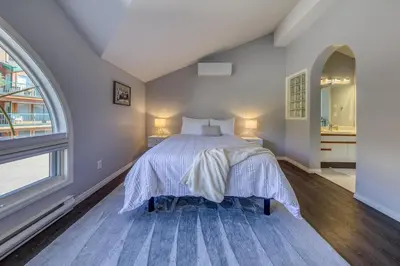 a bedroom with a bed and a large window at Marble Canyon in Fairmont Hot Springs