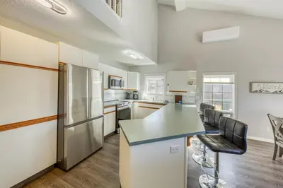 a kitchen with a refrigerator and a counter top at Marble Canyon in Fairmont Hot Springs