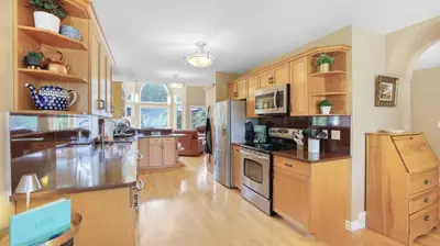 a large kitchen with wooden cabinets and stainless steel appliances at Marble Canyon in Fairmont Hot Springs