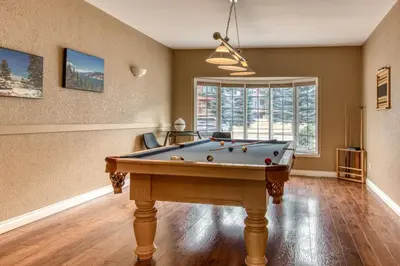 a living room with a pool table in it at Marble Canyon in Fairmont Hot Springs