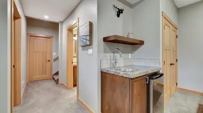 a kitchen with a sink and a hallway at The Residences at Fairmont Ridge in Fairmont Hot Springs