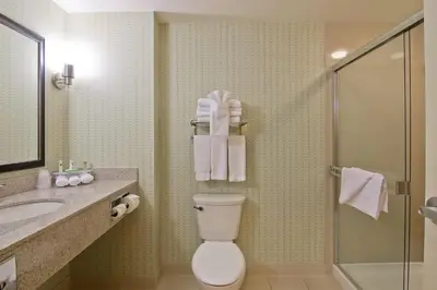 a bathroom with a toilet and a sink and a shower at Wingate by Wyndham Fort Saskatchewan in Fort Saskatchewan