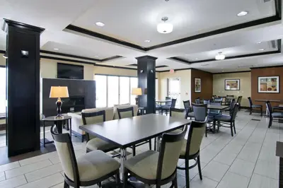 a dining room with tables and chairs at Wingate by Wyndham Fort Saskatchewan in Fort Saskatchewan