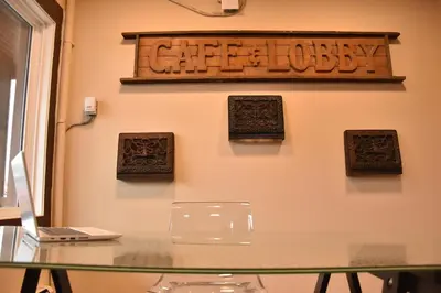 a glass table with a sign on a wall at PARTY HOSTEL - The Canmore Hotel Hostel in Canmore