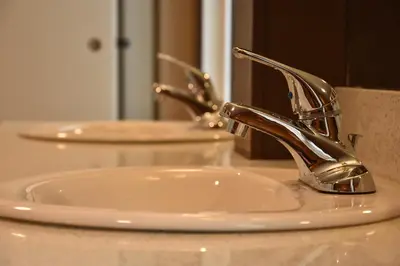 a bathroom sink with a silver faucet on a counter at PARTY HOSTEL - The Canmore Hotel Hostel in Canmore