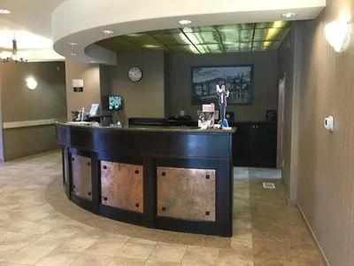 a bar in the middle of a lobby at Super 8 by Wyndham Edson in Edson