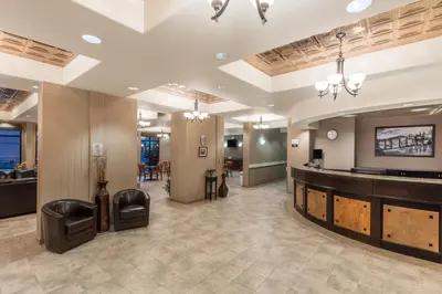 a lobby of a hotel with a bar and a waiting room at Super 8 by Wyndham Edson in Edson