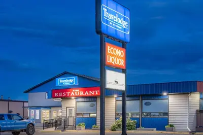 a fast food restaurant sign in front of a store at Travelodge by Wyndham Fort St John in Fort Saint John