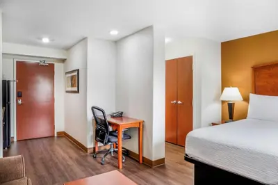 a hotel room with a bed and a desk at Days Inn & Suites by Wyndham Sherwood Park Edmonton in Sherwood Park