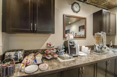 a kitchen counter with a coffee maker and a microwave at Econo Lodge Lloydminster in Lloydminster