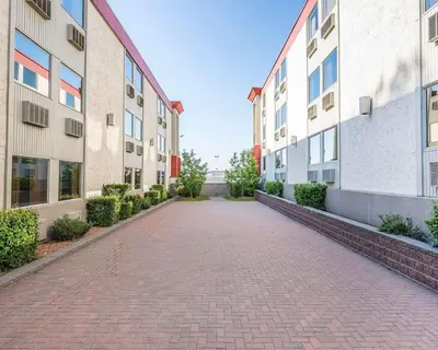 an empty brick road between two buildings at Quality Inn & Conference Centre in Red Deer