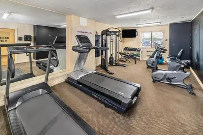 a gym with several treadmills and exercise bikes at Econo Lodge Inn & Suites High Level in High Level