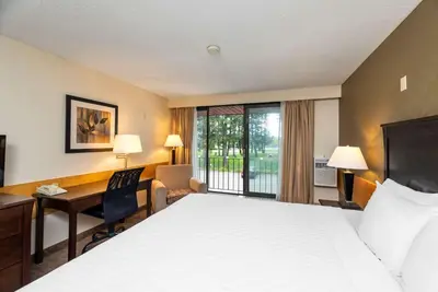 a hotel room with a bed and a desk at Prestige Riverside Lodge Quesnel in Quesnel