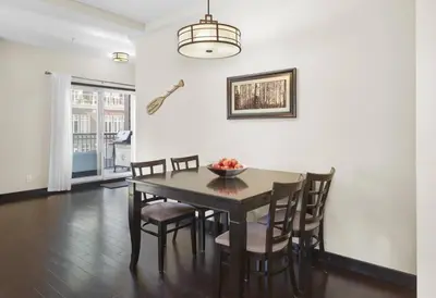 a dining room with a table and chairs at Sundance Suite - Beautiful Condo With Open Pool And Hot Tub in Canmore
