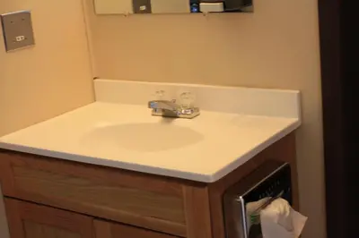 a bathroom sink with a white counter top at Plains Motel in Brooks