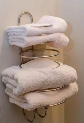 a bunch of towels on a towel rack in a bathroom at Plains Motel in Brooks