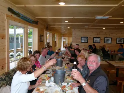 a group of people sitting at a table eating food at Brown's Bay Resort in Campbell River