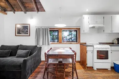 a living room with a couch and a table at Sunwolf Riverside Cabins in Brackendale