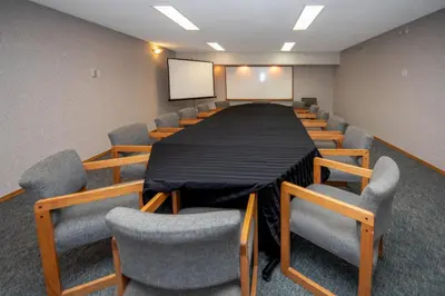 a conference room with a long table and chairs at Coast Fort St John Hotel in Fort Saint John