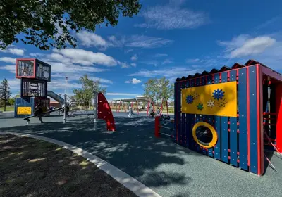 a playground with a colorful play structure in a park at Coast Fort St John Hotel in Fort Saint John