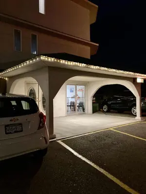 a car parked in a parking lot next to a building at Motel 99 in Grand Forks