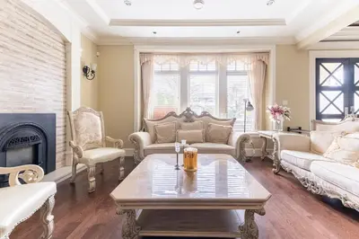 a living room with a table and a fireplace at Mike's Luxury House in Vancouver