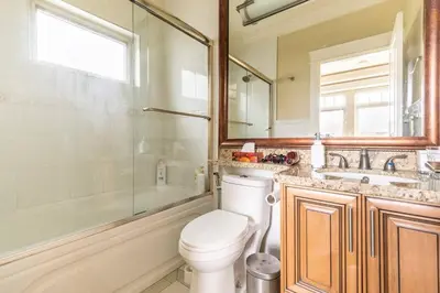 a bathroom with a toilet and a shower and a sink at Mike's Luxury House in Vancouver