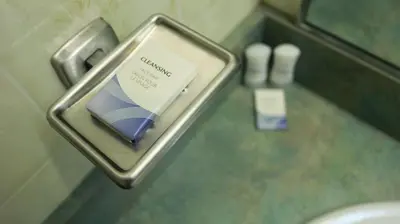 a packet of toothpaste in a metal holder in a bathroom at Elite Hotel -Downtown Center- 