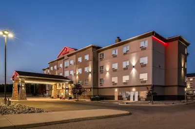 a building with a gas station in front of it at Ramada by Wyndham Lac La Biche in Lac La Biche