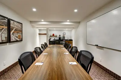 a conference room with a long wooden table and chairs at Canalta Hanna in Hanna