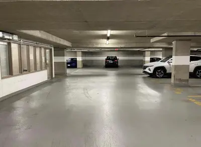 an empty parking garage with two cars parked in it at Vancouver Downtown Central 1 bedroom Condo in Vancouver