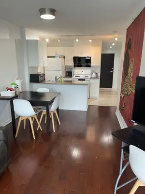 a kitchen and dining room with a table and chairs at Vancouver Downtown Central 1 bedroom Condo in Vancouver