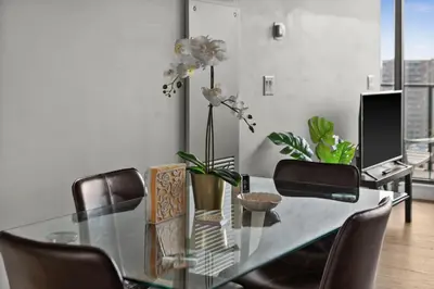 a dining room with a glass table and chairs at GlobalStay Modern Condos Downtown Calgary in Calgary