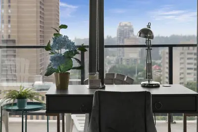 a desk with a lamp and a potted plant on it at GlobalStay Modern Condos Downtown Calgary in Calgary